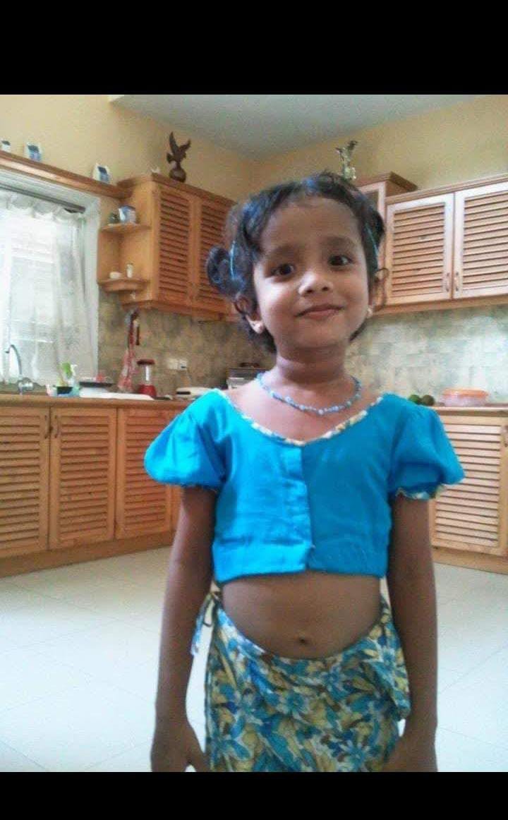 Chuutimanikaa as a little girl in a bright blue outfit